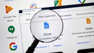A magnifying glass over the Google Docs logo on a computer screen, representing an article about how to change cases on Google Docs