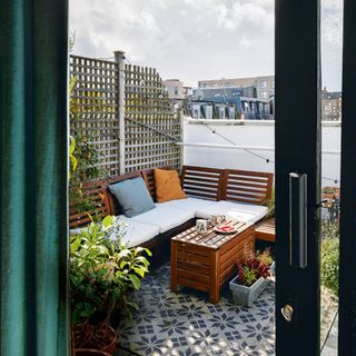 Balcony with garden sofa and outdoor rug