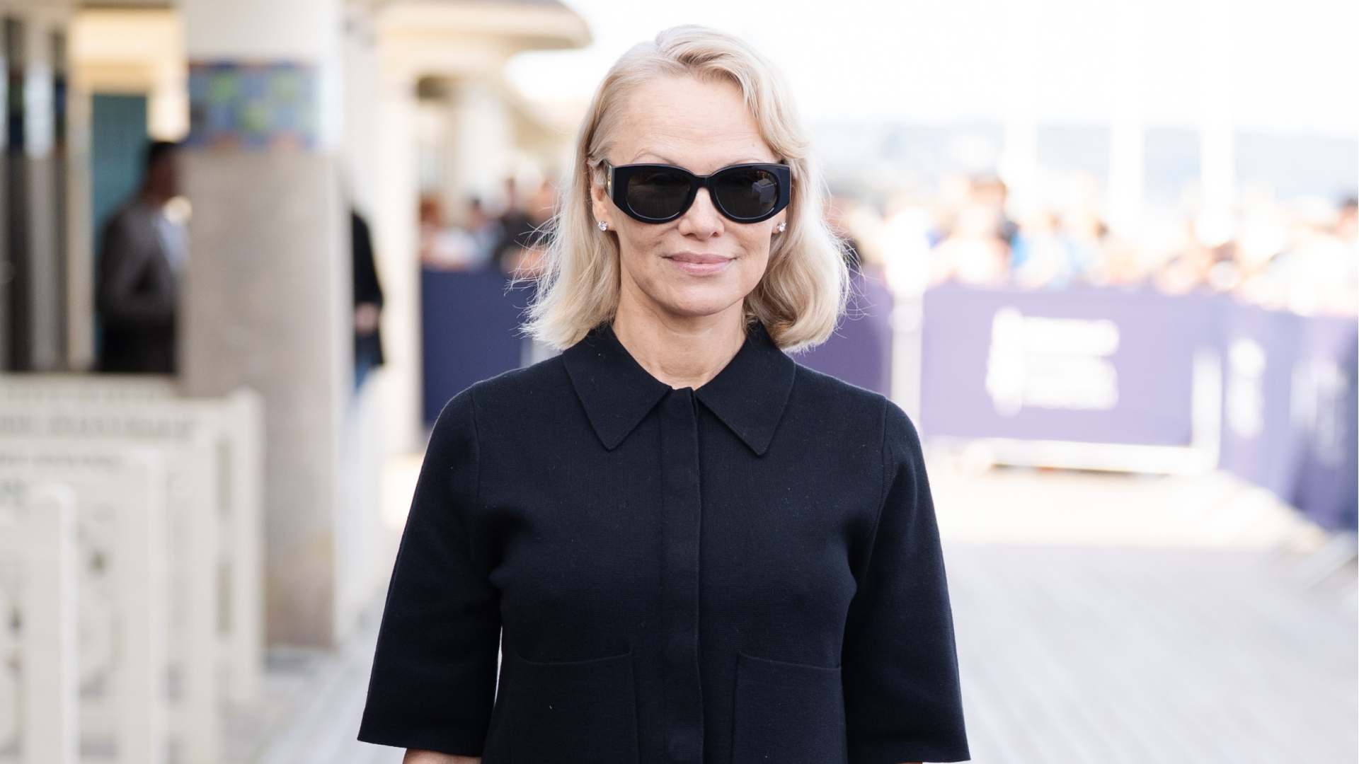 Pamela Anderson in a blonde curled bob hairstyle 