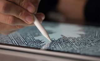 Close up view of a hand creating an intricate black and white drawing with an Apple Pencil on an iPad