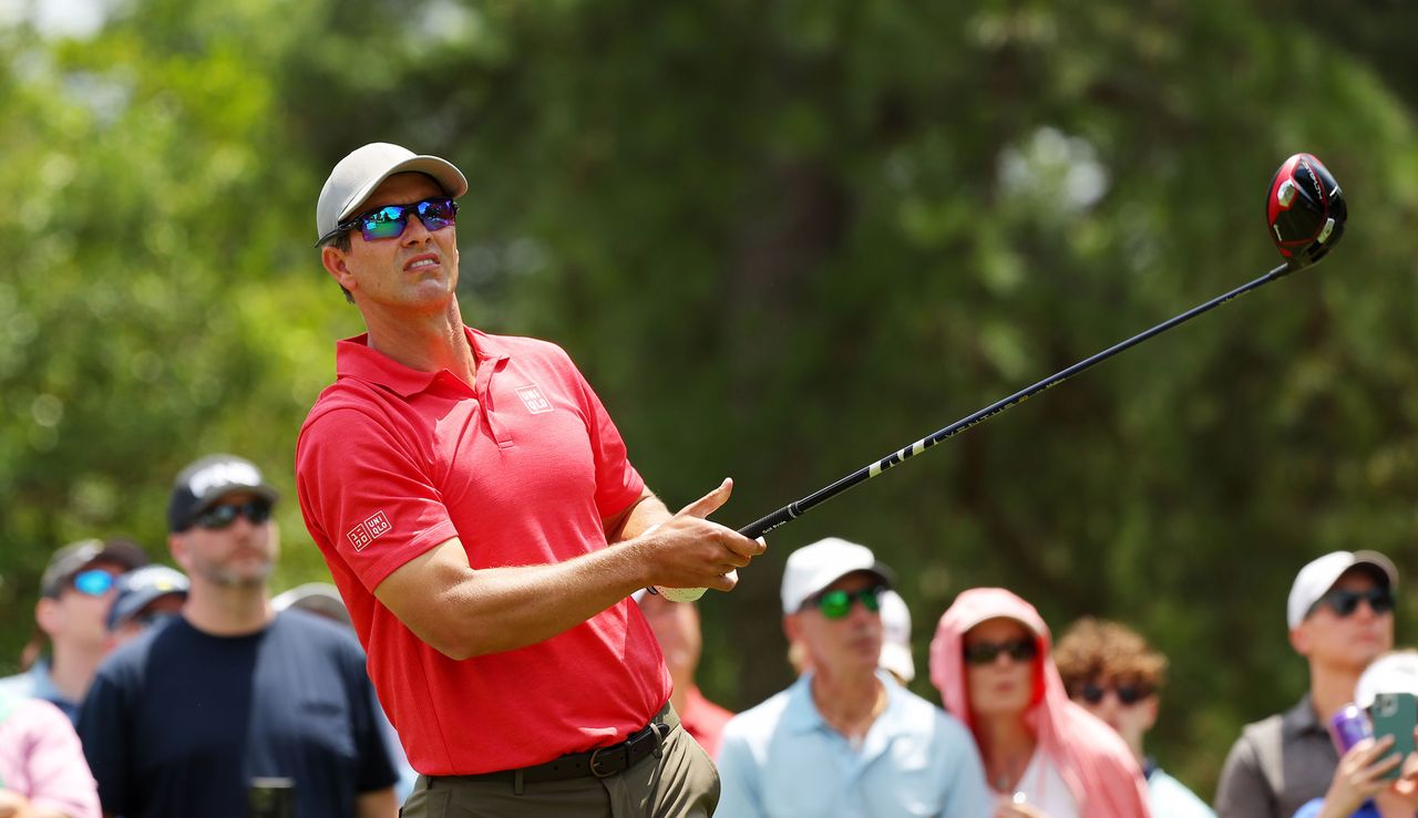 Scott watches his tee shot whilst holding a driver