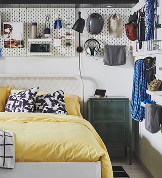 Bedroom with wall storage and yellow bedlinen
