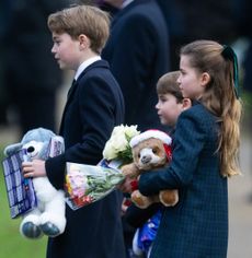 Prince George, Princess Charlotte and Prince Louis holding gifts 