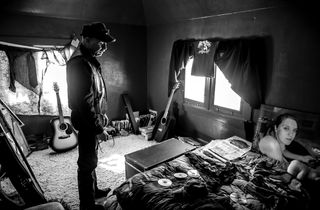 Black and white photo of man in untidy room, image from Leica Women Foto Project Awards 2023