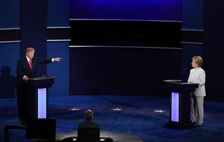 Republican presidential nominee Donald Trump (L) speaks as Democratic presidential nominee former Secretary of State Hillary Clinton looks on during the third U.S. presidential debate at the Thomas & Mack Center on October 19, 2016 in Las Vegas, Nevada