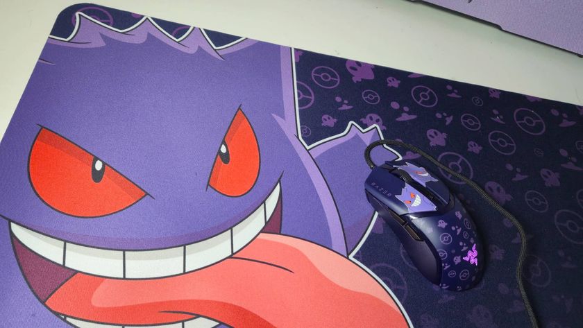 Image of a Gengar mouse mat sitting on a white desk.