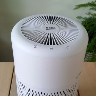 The Beko ATP5100I Air Purifier being tested in a room with a wooden table and pale green walls