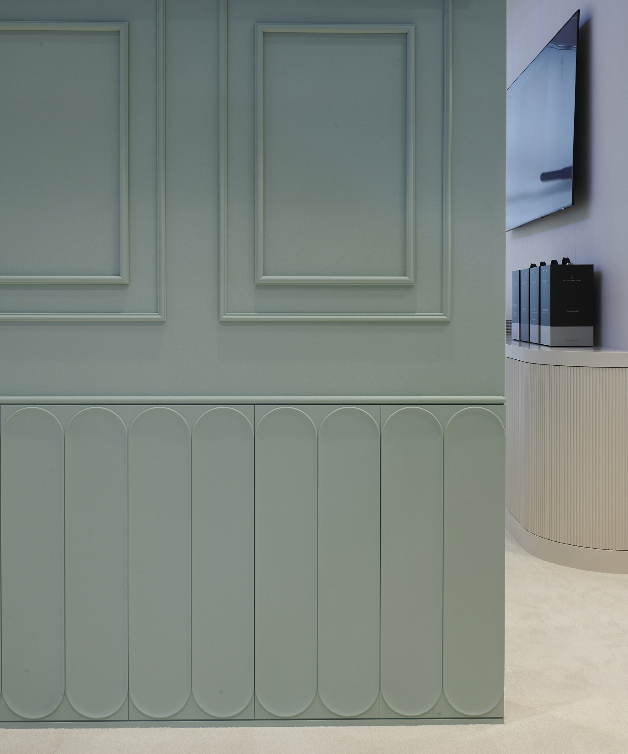hallway with green panelling featuring long narrow lozenge shapes on bottom half of wall and shaker style panels on top