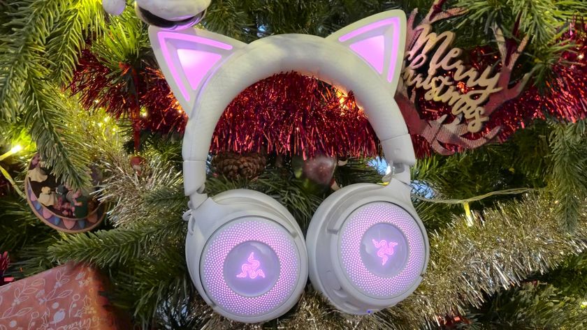 Photo of the white Kraken Kitty V3 Pro headset sitting amongst the branches of a Christmas tree.