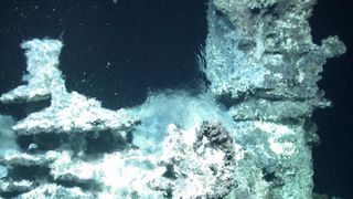 A deep sea hydrothermal vents appears to shimmer as it bubbles out hot water