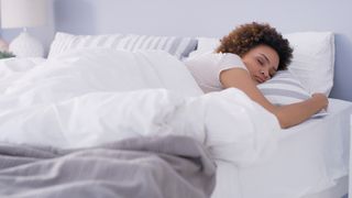 person sleeping comfortably on a mattress to illustrate a w&h article on 'how often you should change a mattress'