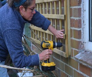 Attaching a wooden trellis to a brick wall
