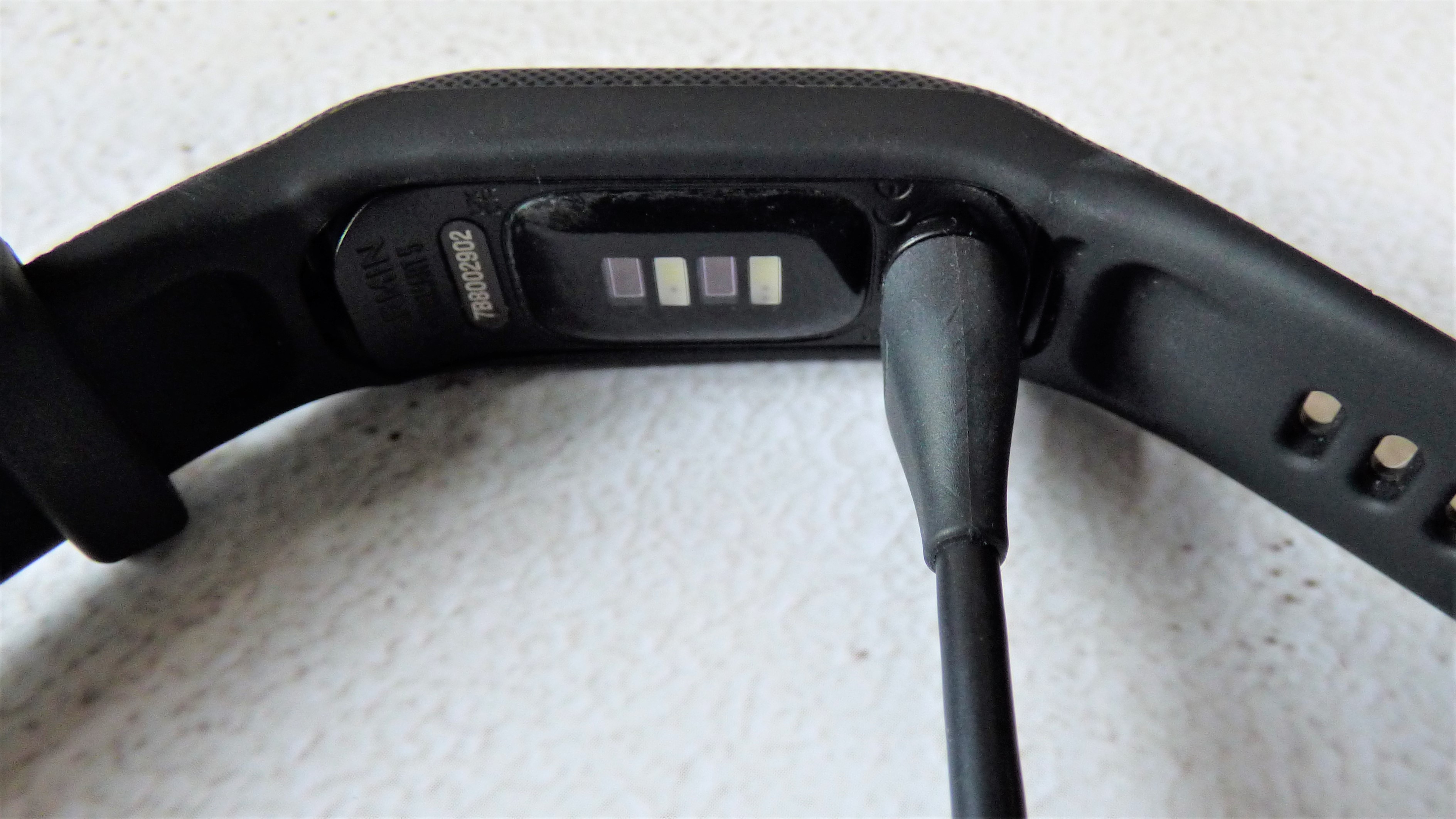 Garmin Vivosmart 5 connected to charging cable