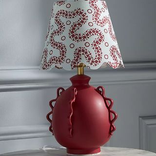 A red table lamp with lampshade