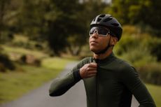 cyclist zips up a thermal jersey