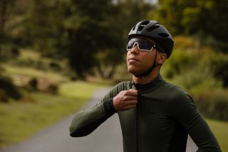 cyclist zips up a thermal jersey