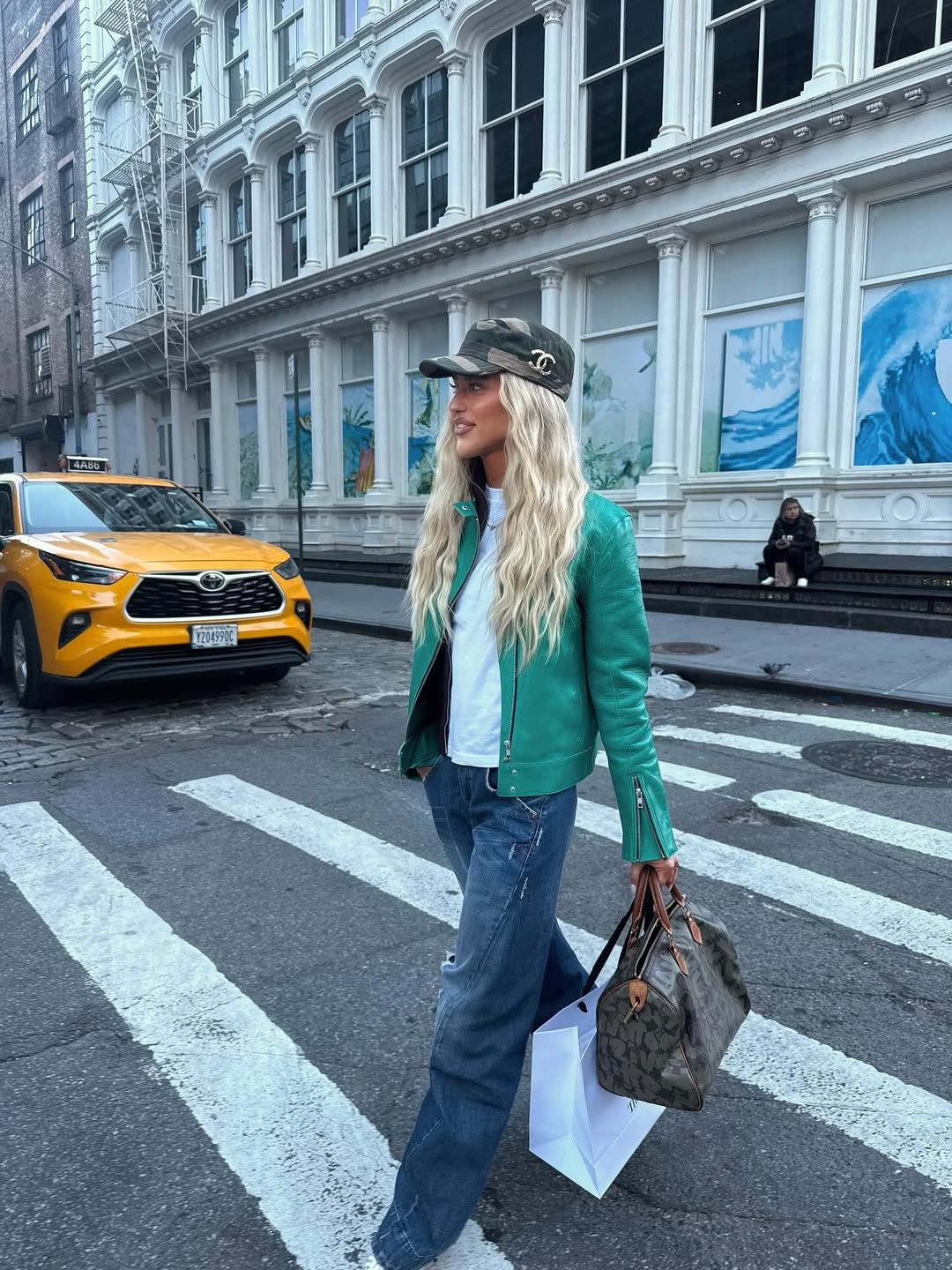 Emili Sindlev in a teal leather jacket.