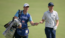 Tom McKibbin and his caddie walk down the fairway