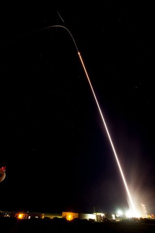 NASA's sounding rocket drew a bright streak in the sky as it lifted off June 29 before releasing colorful artificial clouds.
