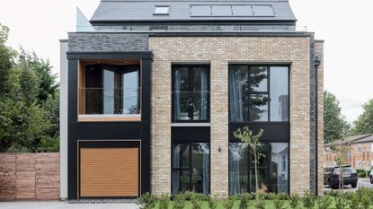 house exterior with brick walls and black door