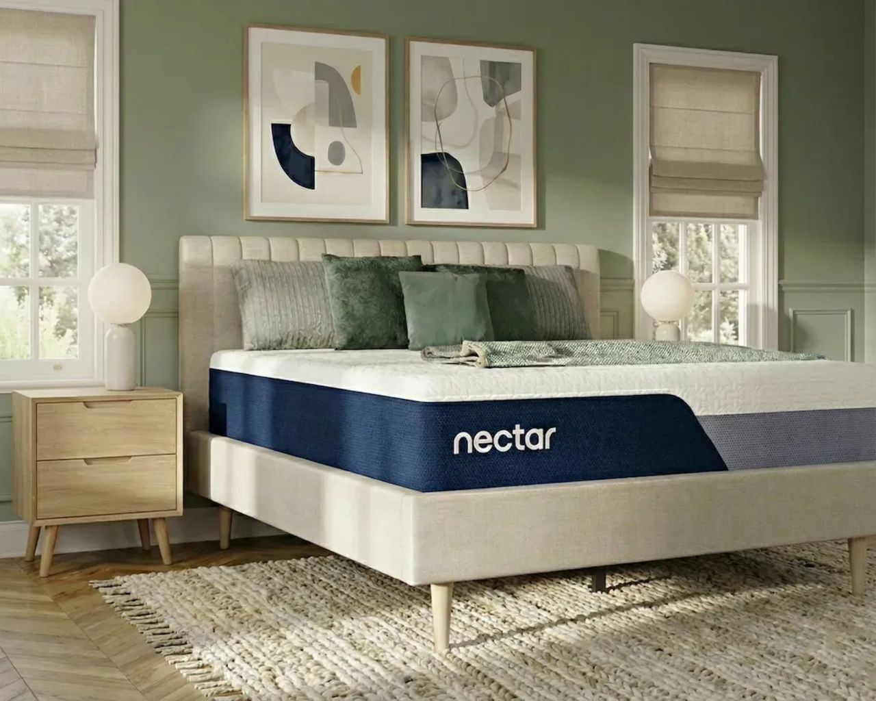 Nectar Classic Memory Foam Mattress in a green bedroom on a white fluted bed with light wood flooring and windows to either side.