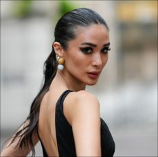 Heart Evangelista wears a sleeveless black long mesh bodysuit with fluffy pants and floral embroidery, outside Roberto Cavalli, during the Milan Fashion Week - Womenswear Spring/Summer 2024 on September 20, 2023 in Milan, Italy. 