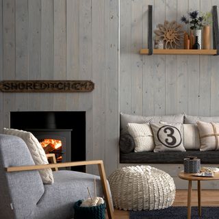 Neutral living room with wooden walls and stove