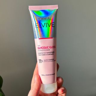 Laura holding L'Oréal Elvive Glycolic Gloss Conditioner - best hair conditioner