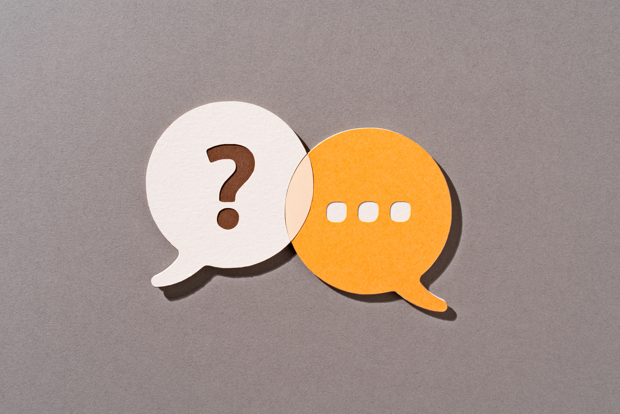 speech bubble with question mark overlapped with speech bubble containing ellipses