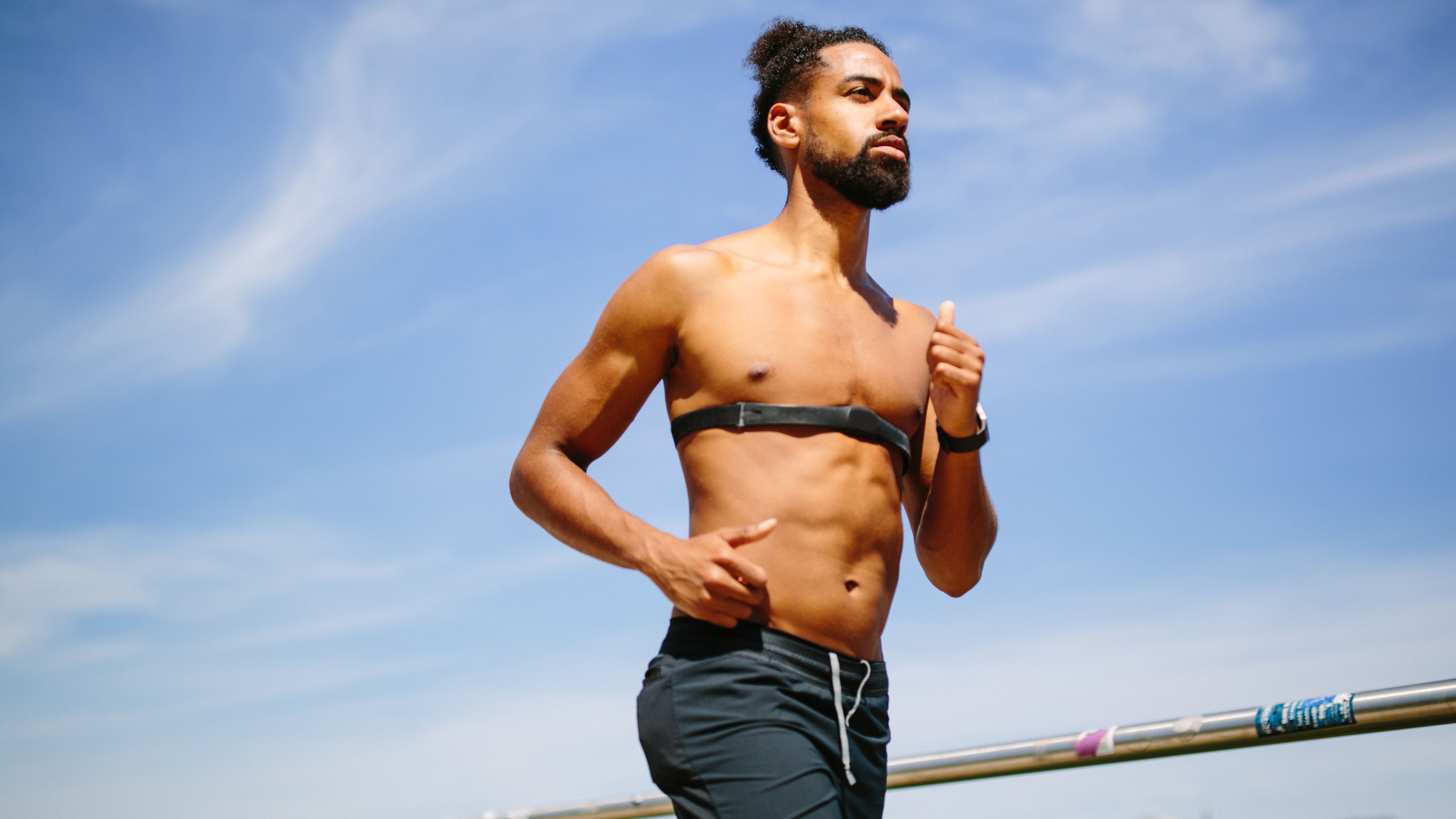 Man running with chest strap heart rate monitor