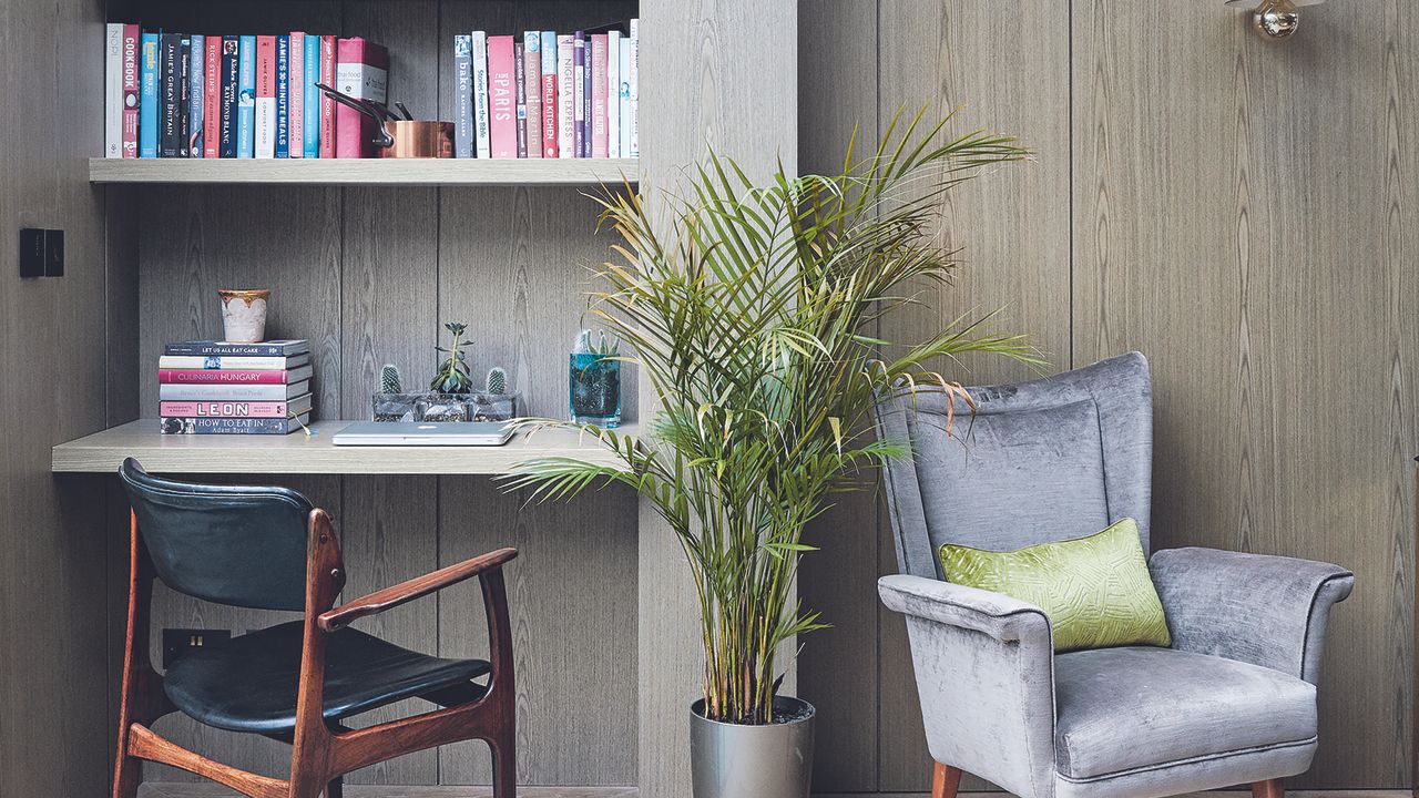 Living room shelves with desk area and armchair.