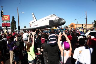 Retired shuttle Endeavour passes a Taco Bell at Martin Luther King Jr. Blvd. and Normandie Ave., Oct. 14, 2012.