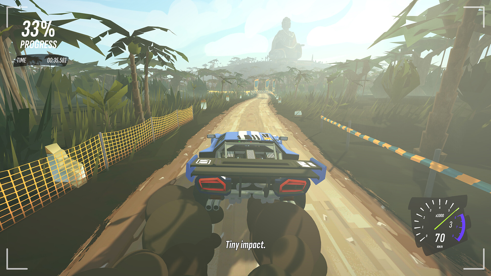 A blue rally car in #DRIVE Rally racing down a dirt road, kicking up dust.