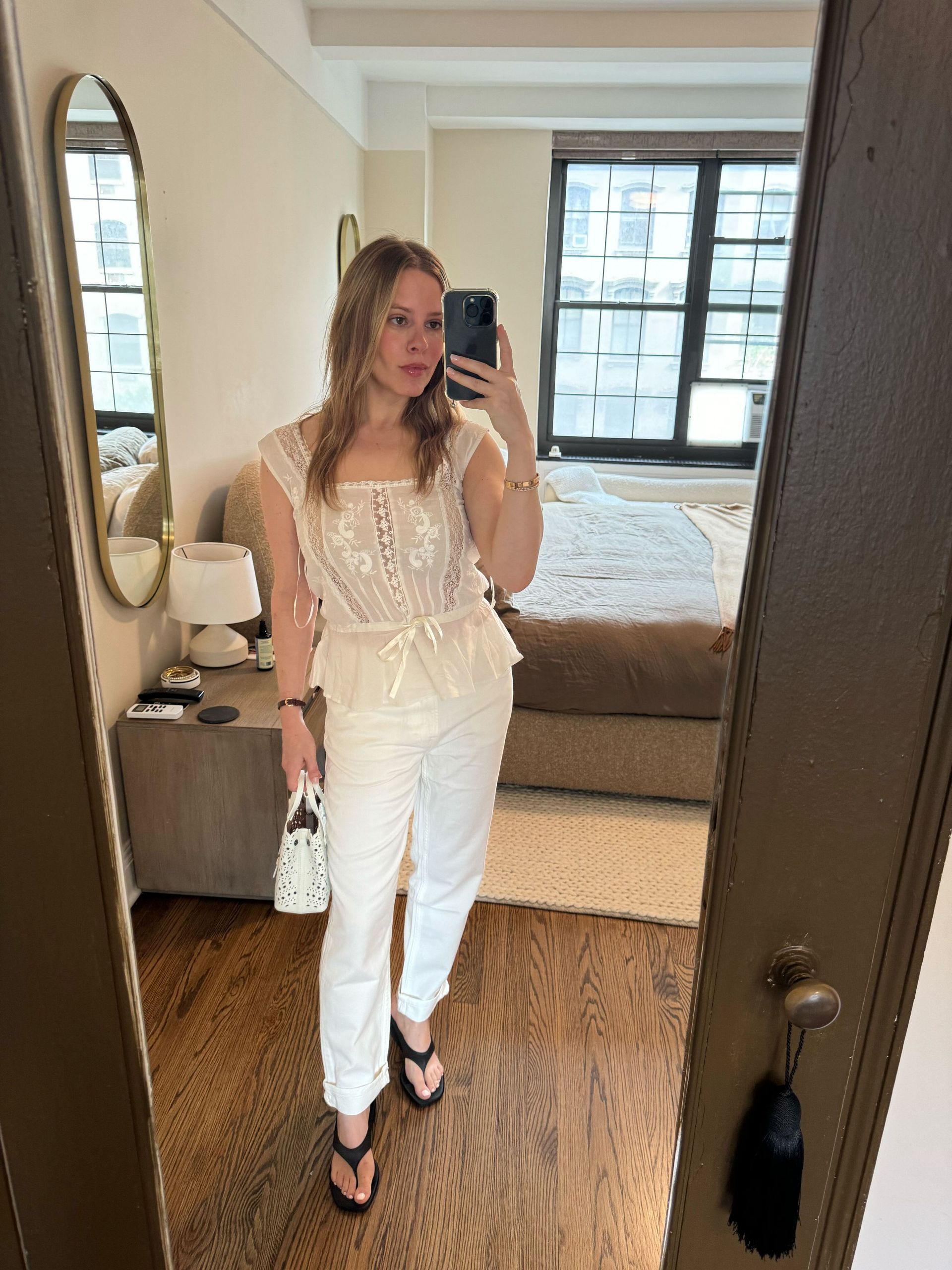 Nikki wears thong wedges, white jeans, and lace top.