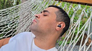 Man relaxing on hammock with Samsung Galaxy Buds 2