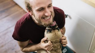 Dog licking the face of man