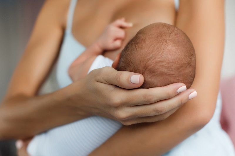 A baby breastfeeding.