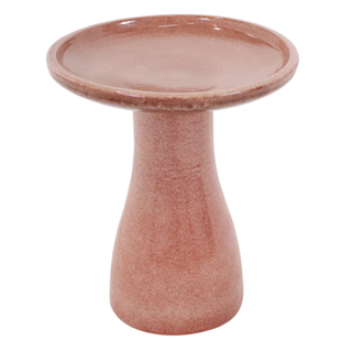 A pink ceramic birdbath