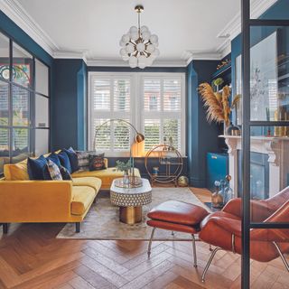 Living room with mustard yellow sofa an leather armchair
