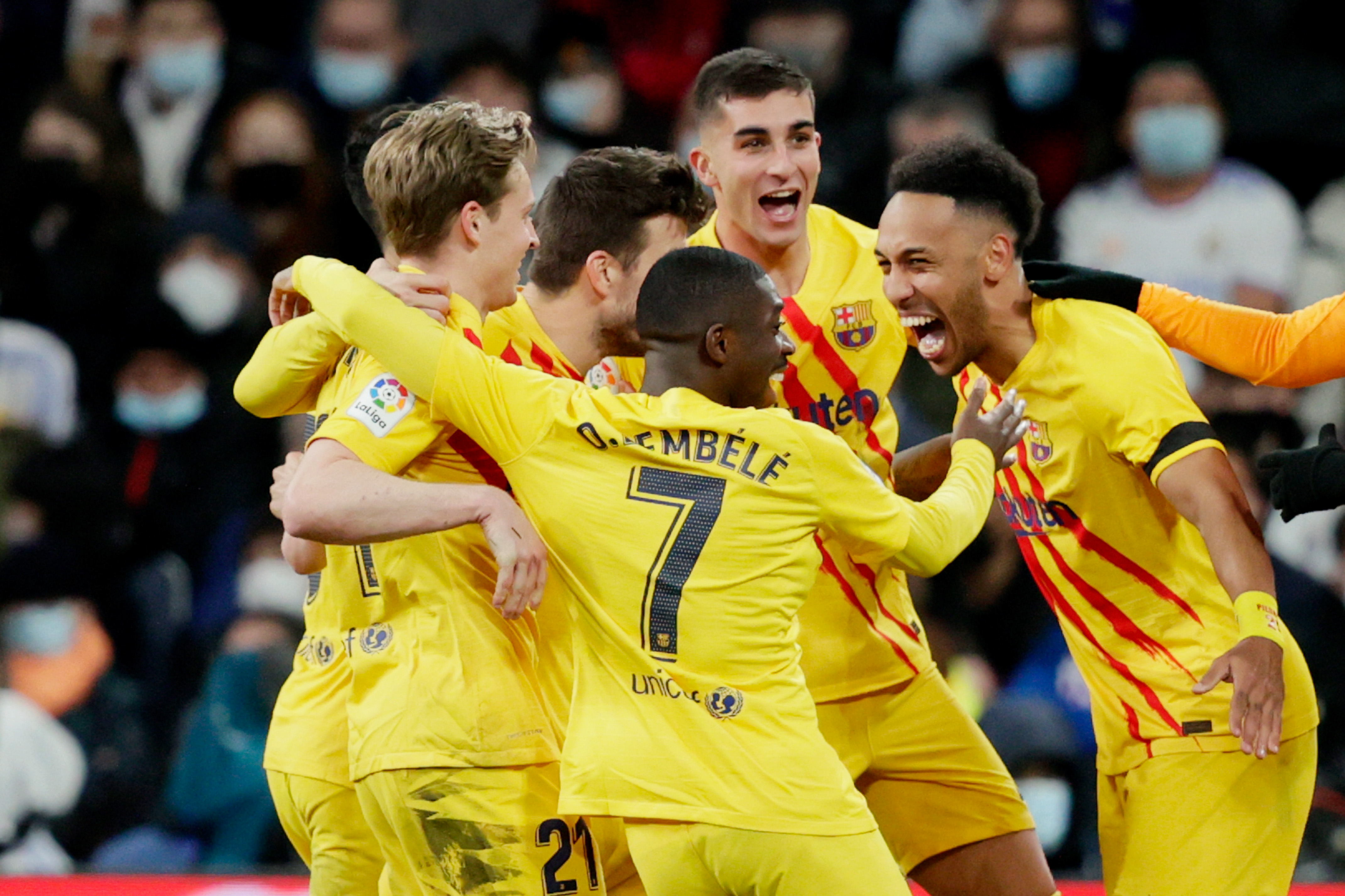 Barcelona players celebrate their third goals in a 4-0 win away to Real Madrid in March 2022.