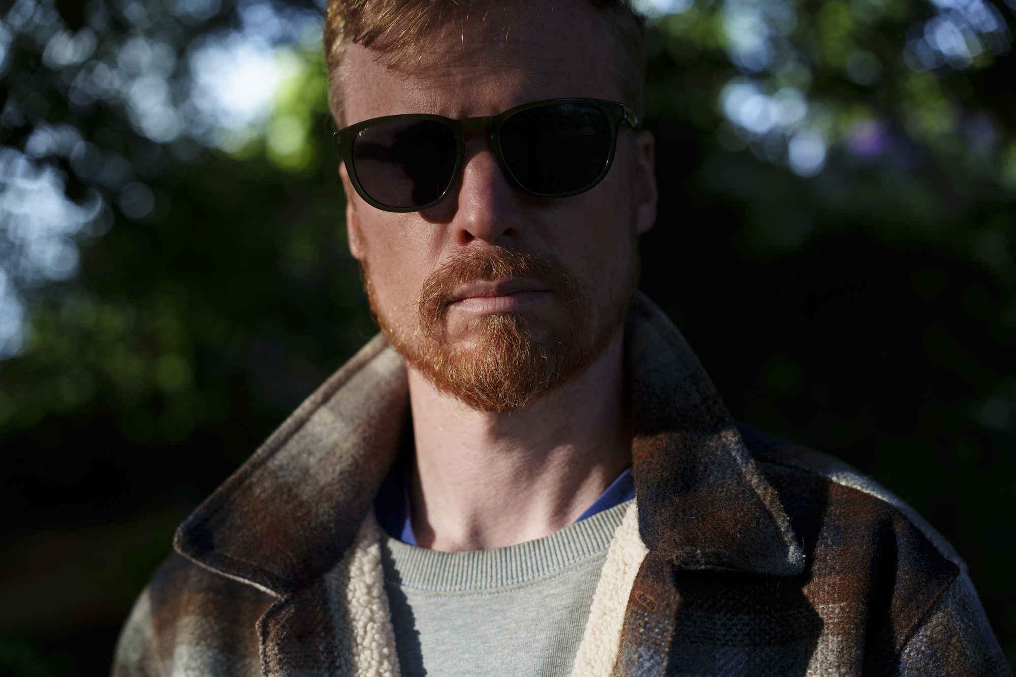 Head and shoulder portrait of a man in sunglasses and jacket, taken with the Sony FE 50-150mm F2 GM lens, taken with the Sony FE 50-150mm F2 GM lens