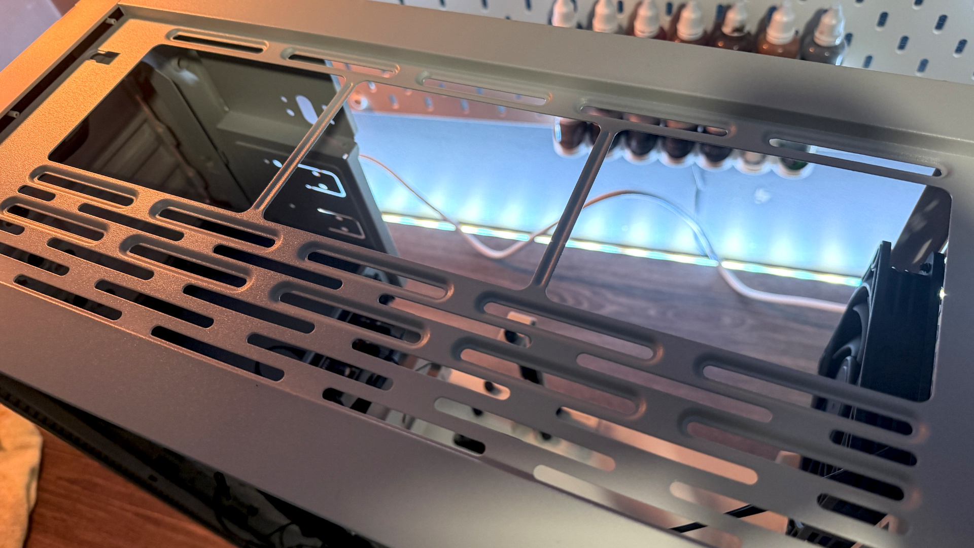 The retro-styled Silverstone FLP02 PC case as a PC is being built into it on a desk.