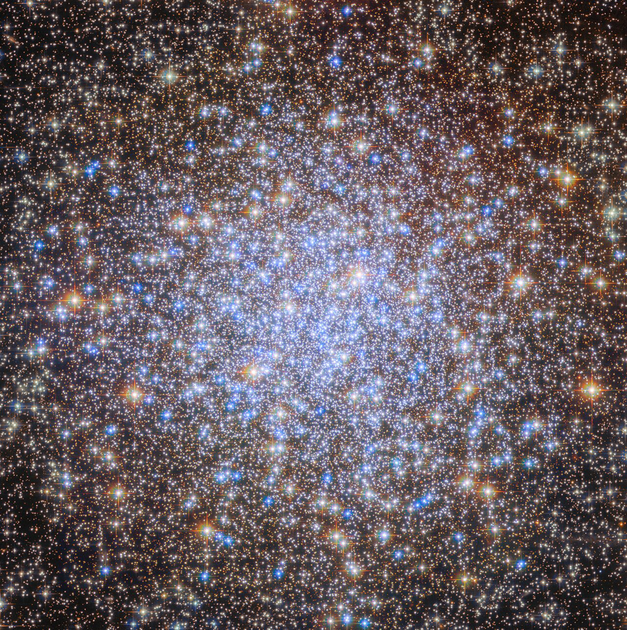 A cluster of brilliant white and golden stars shines in the darkness of space.