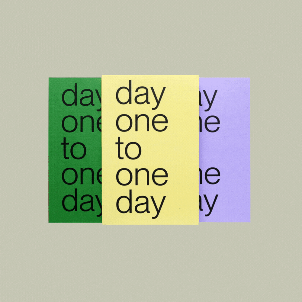 Three notebooks, one green, one pale yellow, one purple, with the title &amp;quot;day one to one day&amp;quot; sit next to each other in a rotating gif alternating that still with an open notebook's view against a pale green background.