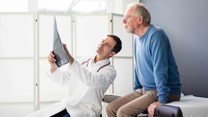 Senior couple talking with doctor in a nursing home