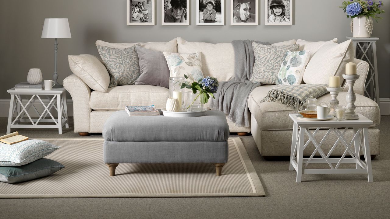 Grey living room with grey carpet and a grey L-shaped sofa