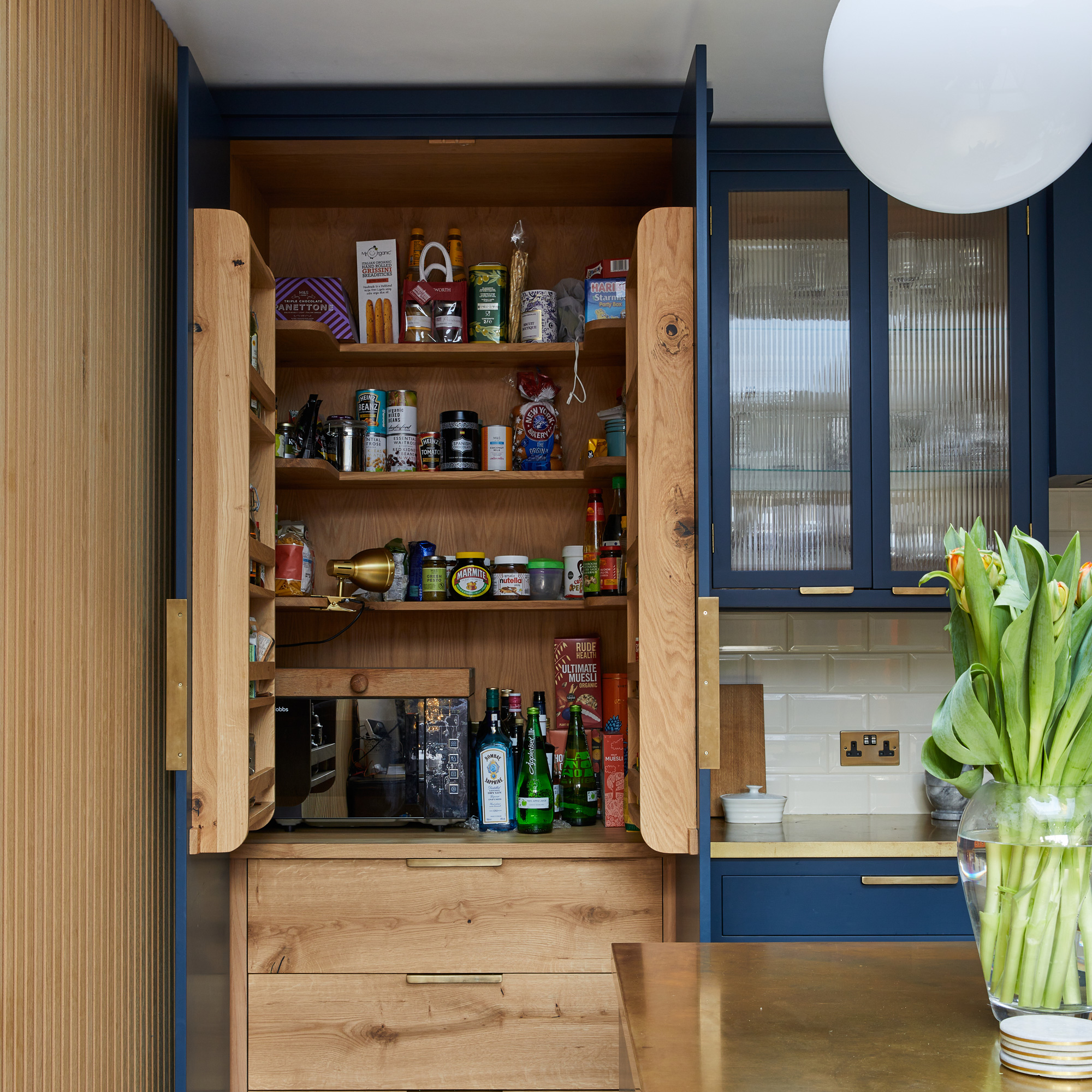 a stylis kitchen pantry with shelving at the top and drawers underneath