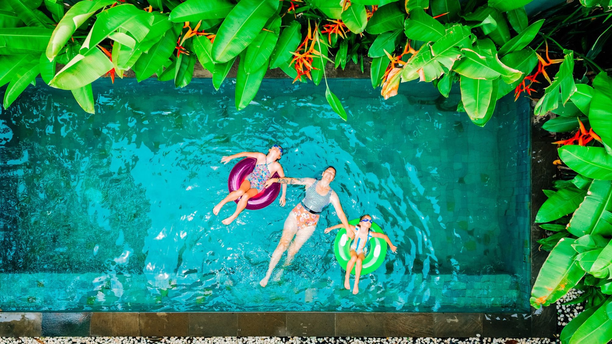 A family enjoying time in a tropical private swimming pool