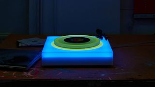 a turntable lit up in blue and green LEDs