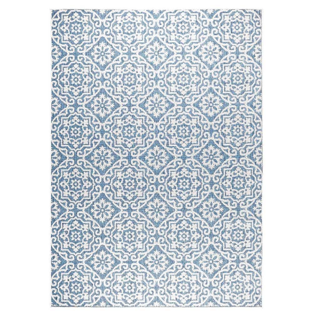 Blue gray patterned outdoor rug shown as a quiet luxury garden accessory